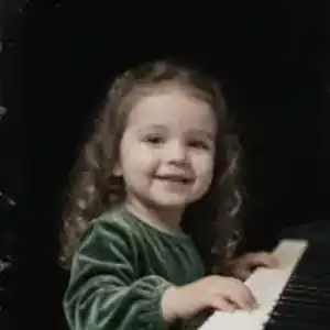 Sarah playing piano at age three